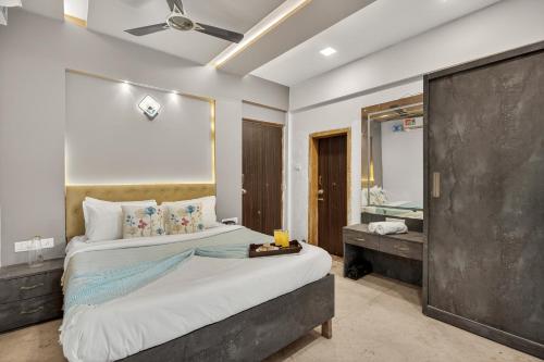 a bedroom with a large bed and a mirror at Alaya Stays Lavender Hills Stunning Hillside 3-BHK Villa With Private Pool, Gazebo and Views in Lonavala