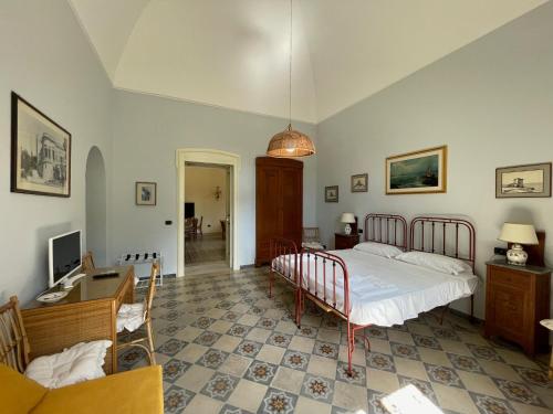 a bedroom with a bed and a desk and a computer at Villa Del Prete in Nardò