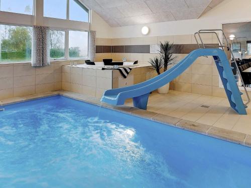 a indoor swimming pool with a slide in a building at 5 star holiday home in Faaborg in Faaborg