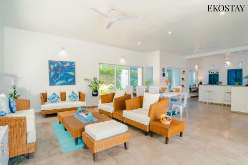 a living room with couches and a table at EKOSTAY - Santo Maria Villa in Pune