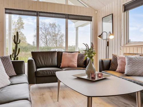 a living room with a couch and a table at 5 star holiday home in Faaborg in Faaborg