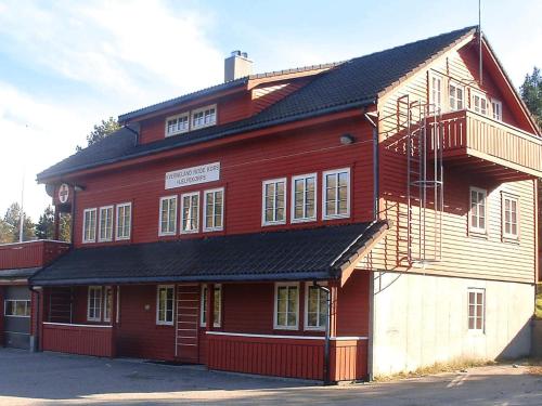 a large red building with a black roof at 27 person holiday home in dyrdal-By Traum in Frafjord