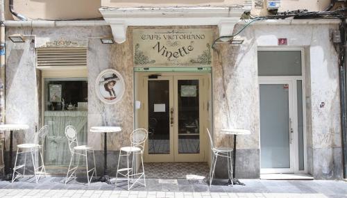 a store with chairs and tables in front of a building at El Rincon de la Merced Terraza Aire acondicionado in Almazán