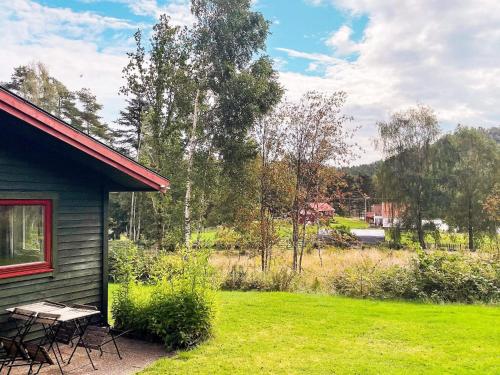 a picnic table and chairs next to a house at 3 person holiday home in HENÅN-By Traum in Henån