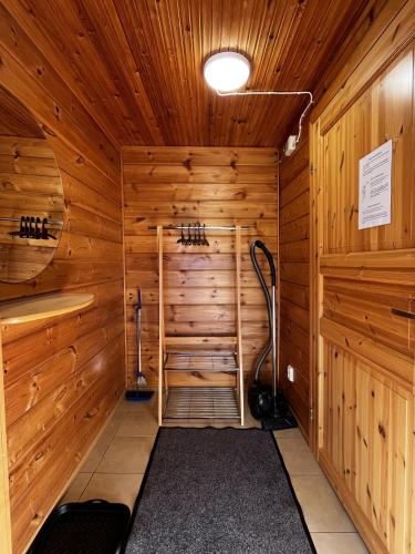 a sauna with wood paneled walls and a ceiling at Motelli Rovaniemi in Rovaniemi