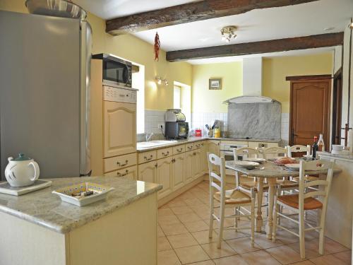 a kitchen with a table and chairs and a refrigerator at Apartment in France near Scenic Landmarks in Estang