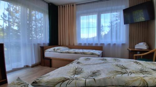 Una cama o camas en una habitación de Penzion U Libuše Luleč