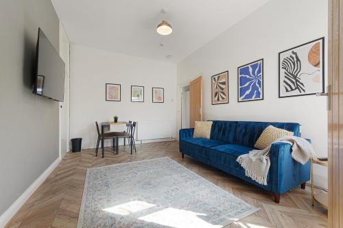 a living room with a blue couch and a table at New Flat, Parking, 3 Bedrooms, Sleeps 6 in Elswick