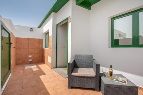a patio with a chair and a table and a shower at El Refugio De Los sueños in Uga