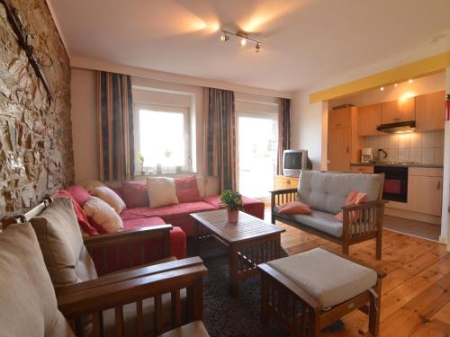 a living room with a couch and a table at Apartment in Halenfeld-Amel with Terrace in Amblève