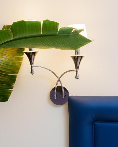 a table with a blue couch in a room at Golden Hotel in Marina di Cecina