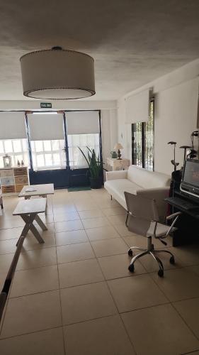 a large living room with a couch and a table at Aires de campo en la ciudad in San Fernando del Valle de Catamarca