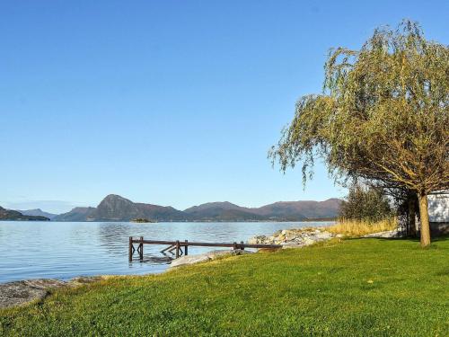 a picnic table on the shore of a lake at Family Oasis with Lake View-By Traum in Ålesund