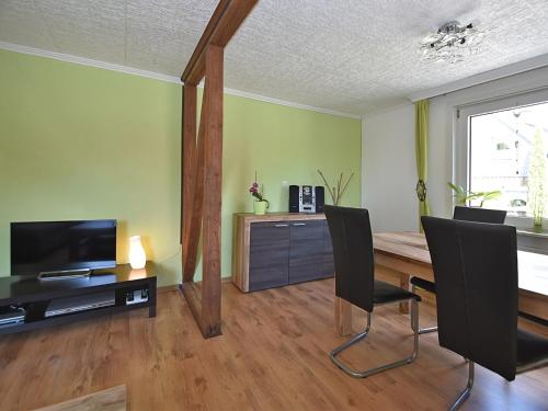 a living room with a wooden table and chairs at Entspannender Skiurlaub in Braunlage in Hohegeiß