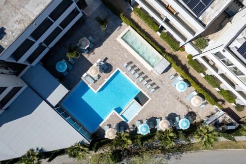 an overhead view of a swimming pool with chairs and umbrellas at Golden Apartments in Marina di Cecina