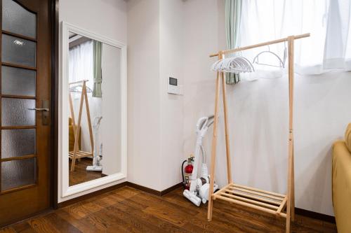 a room with a vacuum cleaner and a mirror at HOTEL CtrlD ASAGAYA Spacious 130 Square Meter Apartment 4 Bedrooms 7 Beds 3 Minute Walk from JR Asagaya Station in Tokyo