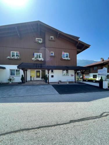 a large brown and white building with a parking lot at Edelweiss Chalet in Uttendorf