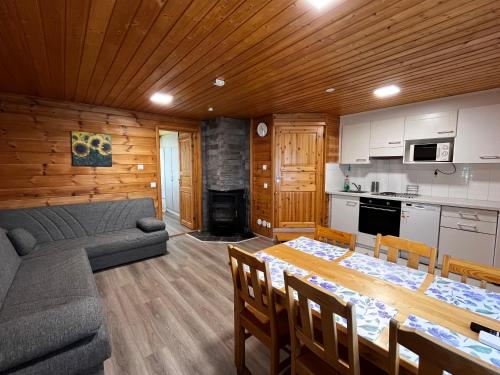 a kitchen and living room with a table and a couch at Motelli Rovaniemi in Rovaniemi