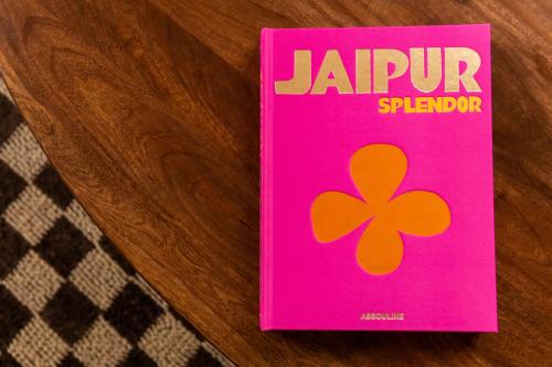 a pink book with a clover on it on a table at The Rokxy Townhouse & Residences - Kings Cross in London