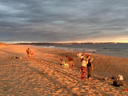 a group of people standing on a beach at Las Coloniales in Sauce de Portezuelo