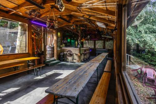 a wooden bench in a bar with a table at 4 Évszak Hegyihotel in Mátraháza