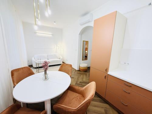a room with a white table and chairs and a bed at Mirage Medic Hotel in Budapest