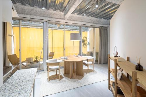 a dining room with a table and some chairs at まえばしガレリアArt residence & Hotel in Maebashi