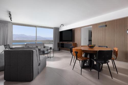 a living room with a couch and a table at Luxury Apartments And Studios At Sea Side By Rently in Eilat