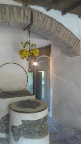 a room with a stone floor and a chandelier at La Cantina Del Sole in Riccò del Golfo di Spezia