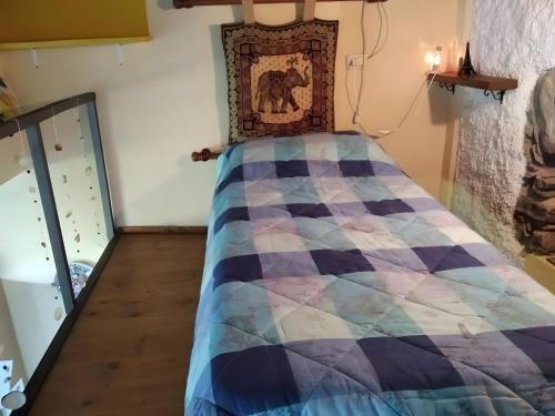 a bedroom with a bed with a quilt on it at La Cantina Del Sole in Riccò del Golfo di Spezia