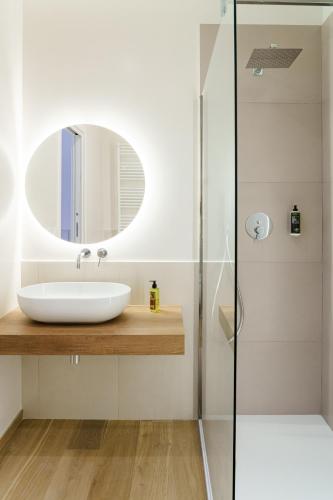 a bathroom with a sink and a mirror at Civico 7 - Apulian Rooms in Conversano