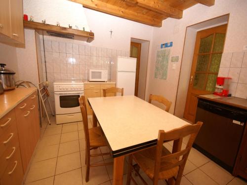a kitchen with a table and chairs in it at Holiday Home in Esmoulières near Forest in Esmoulières