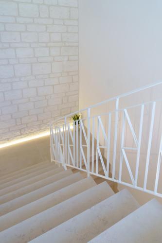 a white staircase with a potted plant on it at Civico 7 - Apulian Rooms in Conversano