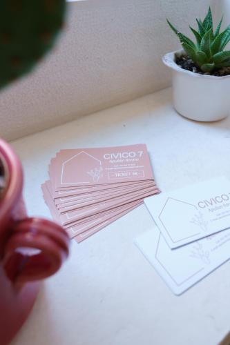 a table with two cards and a potted plant at Civico 7 - Apulian Rooms in Conversano