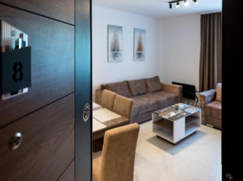 a living room with a couch and a table at Crystal Luxury Apartments in Vrdnik
