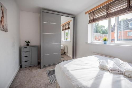 a bedroom with a bed and a walk in closet at Silver Grove in Stoke on Trent