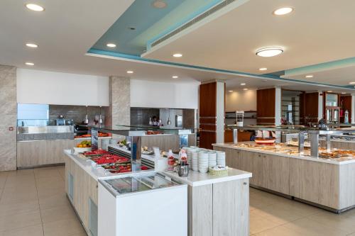 a restaurant with a buffet line with food at Belair Beach Hotel in Ixia