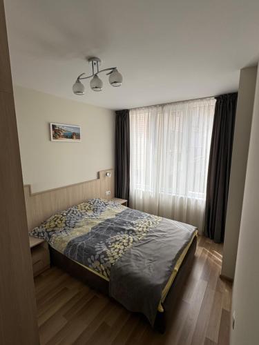 a bedroom with a bed and a window at Nikea apart 2 in Velingrad