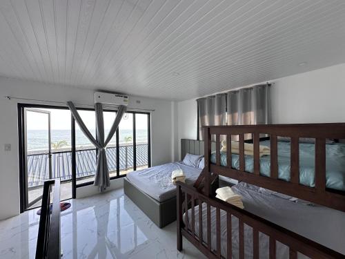 a bedroom with two bunk beds and a balcony at Verdadero Norte Beach Resort in Luna