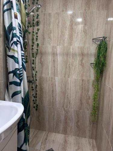 a bathroom with a shower with a toilet and a sink at Damyanov residence in Pazardzhik