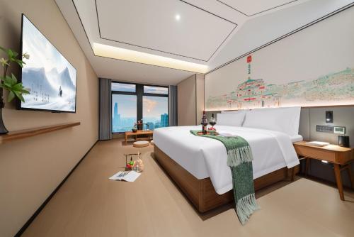 a bedroom with a large bed and a large window at Chongqing Xingcheng Chengyijing Hotel Management Co., Ltd in Chongqing