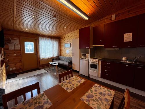 a kitchen with a table and a dining room at Motelli Rovaniemi in Rovaniemi