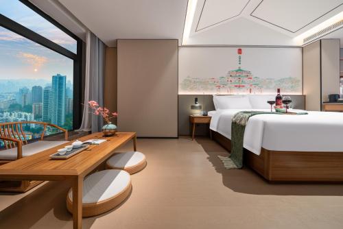 a bedroom with a large bed and a large window at Chongqing Xingcheng Chengyijing Hotel Management Co., Ltd in Chongqing