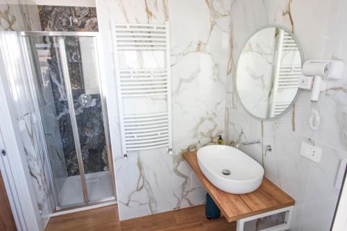 a bathroom with a sink and a mirror at Dadà - Luxury Suite in Bari
