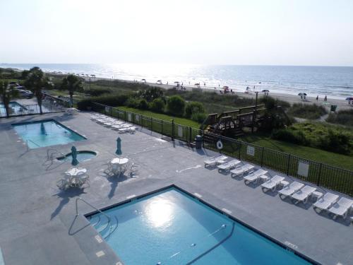 an aerial view of a swimming pool and the beach at Tropical Seas Hotel in Myrtle Beach