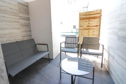 a room with two chairs and a couch and a table at Dadà - Luxury Suite in Bari