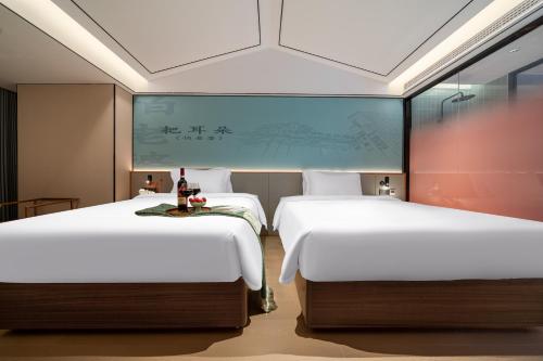 two beds in a hotel room with at Chongqing Xingcheng Chengyijing Hotel Management Co., Ltd in Chongqing