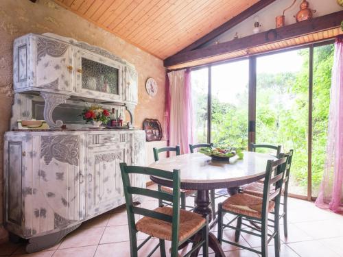 a kitchen with a table and chairs in a room at Peaceful Villa in Saint-Jory in Nanthiat
