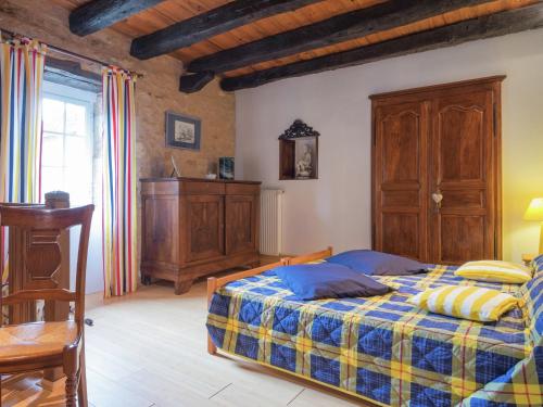 a bedroom with a bed with a blue and yellow blanket at Peaceful Villa in Saint-Jory in Nanthiat