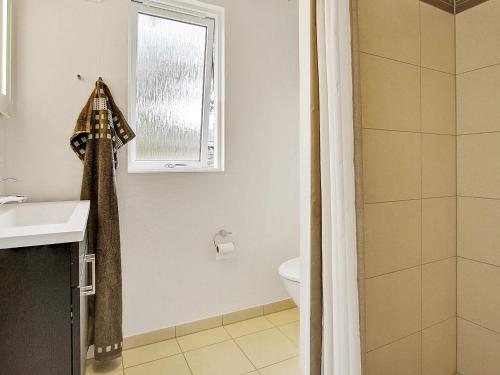 a bathroom with a toilet and a sink and a window at Luxury Retreat in Liseleje - By Traum Ferienwohnungen in Liseleje